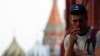 FILE - A man smokes a cigarette at Moscow's Red Square.