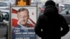 A person passes a defaced campaign poster of far-right presidential candidate Norbert Hofer in Vienna, Austria, Dec. 5, 2016. Centrist Alexander Van der Bellen defeated Hofer in Sunday's election, a win welcomed by moderate politicians across Europe.