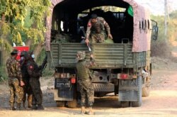 Soldiers keep watch at a guesthouse, where members of parliament reside, in the country's capital Naypyidaw, Feb. 2, 2021.