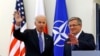 U.S. Vice President Joe Biden (L) waves as he meets Polish President Bronislaw Komorowski in Warsaw March 18, 2014.