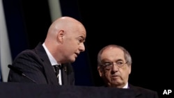 ILE - In this Wednesday, June 5, 2019 file photo, FIFA President Gianni Infantino, left, speaks with French Football Federation President Noel Le Graet before the start of the 69th FIFA congress in Paris. 