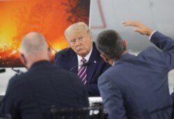 U.S. President Donald Trump listens during a briefing on wildfires in McClellan Park, California, Sept. 14, 2020.