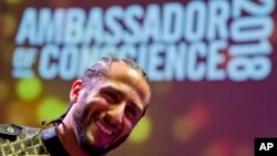 Former NFL quarterback and social justice activist Colin Kaepernick poses with guests after receiving the Amnesty International Ambassador of Conscience Award for 2018 in Amsterdam, April 21, 2018.