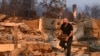 A resident recovers a safe from their home after it was destroyed during the Palisades Fire in Pacific Palisades, a neighborhood of Los Angeles, California, on January 9, 2025.