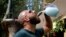In this Sept. 8, 2018 photo, a Lebanese man drinks arak from a traditional glass pitcher during a festival that celebrates Lebanon's national alcoholic drink, in the town of Taanayel, east Lebanon. 