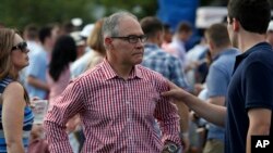 FILE - Environmental Protection Agency Administrator Scott Pruitt stands on the South Lawn during an afternoon picnic for military families at the White House, July 4, 2018, in Washington. 