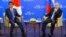 Russian President Vladimir Putin, right, and Japanese Prime Minister Shinzo Abe pose for a photo during their meeting in Vladivostok, Russia, Sept. 2, 2016. 