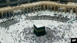 A relatively few number of Muslims pray around the Kaaba, the cubic building at the Grand Mosque, in the Muslim holy city of Mecca, Saudi Arabia, March 4, 2020. 