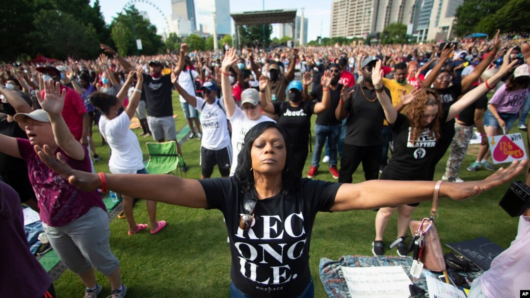 A woman prays during an event hosted by OneRace Movement, a religious organization, at Atlanta’s Centennial Olympic Park to commemorate Juneteenth, the date of the emancipation of enslaved African Americans in the U.S., on June 19, 2020. 