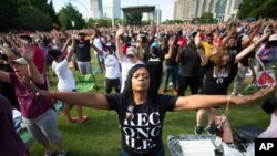 A woman prays during an event hosted by OneRace Movement, a religious organization, at Atlanta’s Centennial Olympic Park to commemorate Juneteenth, the date of the emancipation of enslaved African Americans in the U.S., on June 19, 2020. 