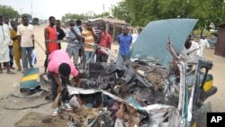 FILE - People gather at the scene of an explosion in Maiduguri, Nigeria, Oct. 12, 2016. Radical Islamic militants from the Boko Haram group are suspected to have carried out new attacks Wednesday.