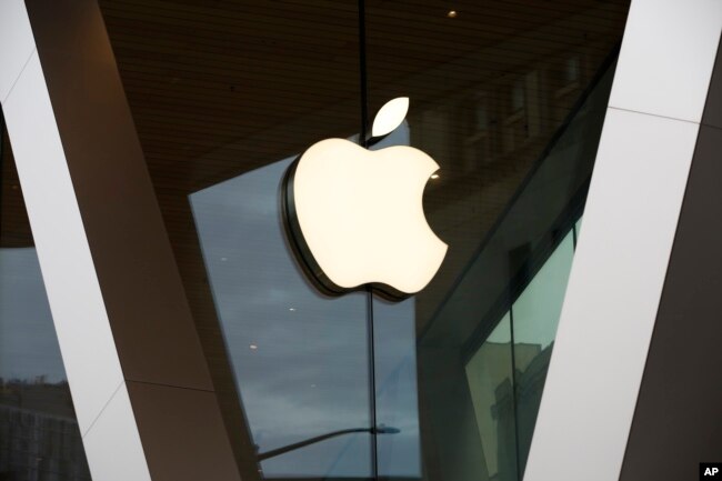 FILE - An Apple logo adorns the facade of the downtown Brooklyn Apple store in New York, Saturday, March 14, 2020. (AP Photo/Kathy Willens, File)