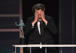 Joaquin Phoenix reacts as he accepts the award for outstanding performance by a male actor in a leading role for "Joker" at the 26th annual Screen Actors Guild Awards.