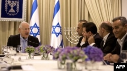 Israeli President Reuven Rivlin, left, speaks during consultations with representatives of the Joint List, right, an alliance of four small Arab-backed parties, to hear whom they would recommend for prime minister at his residence in Jerusalem, March 22, 