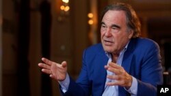 FILE - American film director Oliver Stone gestures during an interview with The Associated Press in Sarajevo, Bosnia, Aug. 15, 2017. According to Iranian news reports, Stone is currently in Tehran.