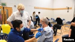 British Prime Minister Boris Johnson visits Stow Health vaccination center in Westminster, London, Dec. 13, 2021. 