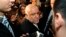 Iranian Oil Minister Bijan Zanganeh is surrounded by journalists and security staff as he arrives at his hotel ahead of an OPEC meeting in Vienna, Dec. 3, 2013.