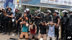 FILE - Egyptian security forces detain supporters of ousted President Mohamed Morsi as they clear a sit-in camp set up near Cairo University in Cairo's Giza district, Egypt, Aug. 14, 2013.