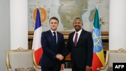 Ethiopia's Prime Minister Abiy Ahmed, right, shakes hands with France's President Emmanuel Macron at the newly renovated Ethiopia's historic National Palace in Addis Ababa on Dec. 21, 2024, as part of a two-day visit to Djibouti and Ethiopia. 