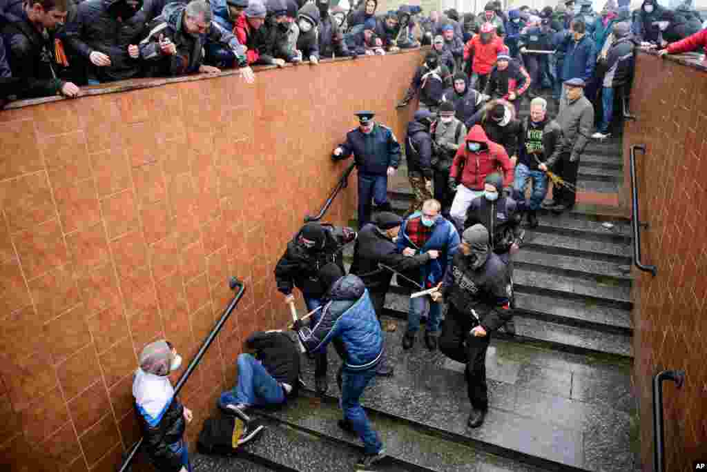 Pro-Russia supporters beat a pro-Western activist during a pro-Russian rally in Kharkiv, Ukraine, April 13, 2014.