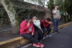 People react near the area where a shooting took place in Mexico City, Mexico, June 26, 2020.