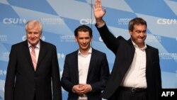 From left, Markus Soeder, Bavaria's State Premier and top candidate of the conservative Christian Social Union party for the regional elections in Bavaria, Austrian Chancellor Sebastian Kurz and German Interior Minister Horst Seehofer take the stage at a final election rally in Munich, Germany, Oct. 12, 2018.