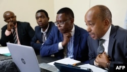 FILE - Lawyers (R-L) Tom Macharia, Mbiyu Kamau, Kelvin Kubai, and Gilbert Njoronge, representing the victims of abuses allegedly committed by Del Monte Kenya security guards, attend a virtual court proceeding at the Thika Law courts in Kiambu county on February 8, 2024.