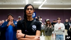 Eep Bolaño listens as IAM District 751 president Jon Holden announces that the union voted to accept a new contract offer from Boeing,Nov. 4, 2024, at their union hall in Seattle. 