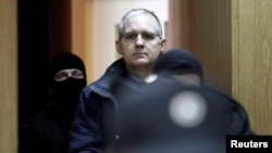 FILE - Former U.S. marine Paul Whelan, who is being held on suspicion of spying, is escorted out of a courtroom, in Moscow, Russia, Feb. 22, 2019. 