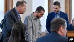 Hadi Matar, center, charged with severely injuring author Salman Rushdie in a 2022 knife attack, reacts after being found guilty on all counts in Chautauqua County court in Mayville, N.Y., Feb. 21, 2025.