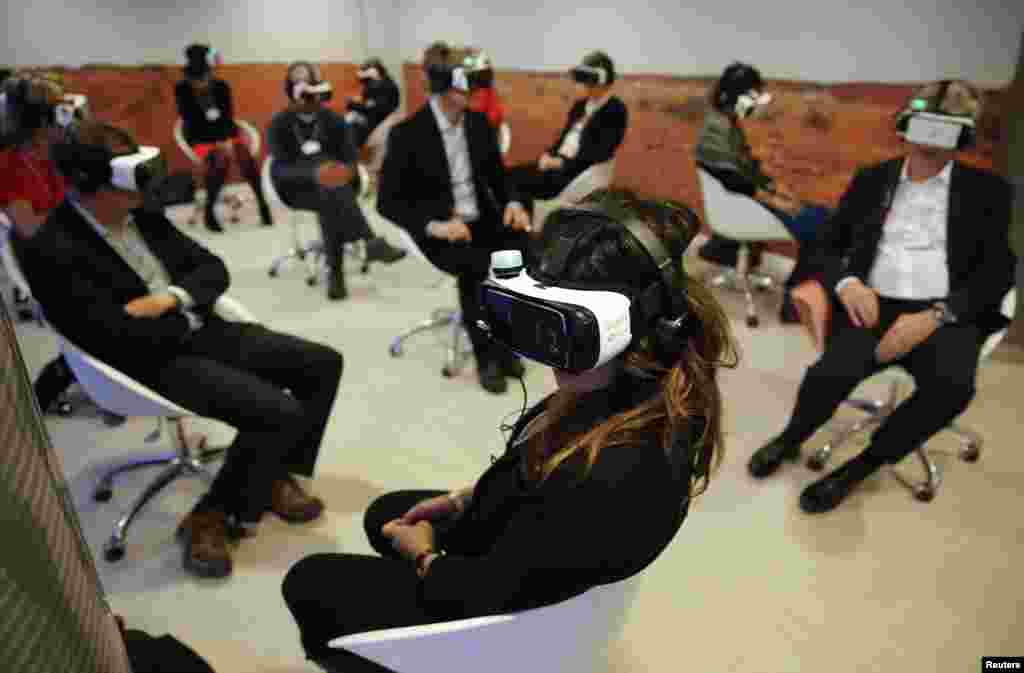Participants attend the &#39;Collisions. A Virtual Reality World Premiere&#39; event at the annual meeting of the World Economic Forum (WEF) in Davos, Switzerland.