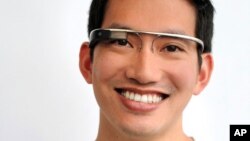 In this undated handout photo provided by the Google group's "Project Glass", an early prototype of Google's futuristic Internet-connected glasses, are modeled.