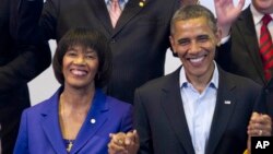 FILE - President Barack Obama and Jamaican Prime Minister Portia Simpson Miller pose for a photo at a multilateral meeting with Caribbean leaders during the sixth Summit of the Americas in Cartagena, Colombia, April 15, 2012.