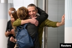 FILE - Former hostage Fernando Simon Marman Gaza, reunites with a loved one at Sheba Medical Center, in Ramat Gan, Israel, February 12, 2024.