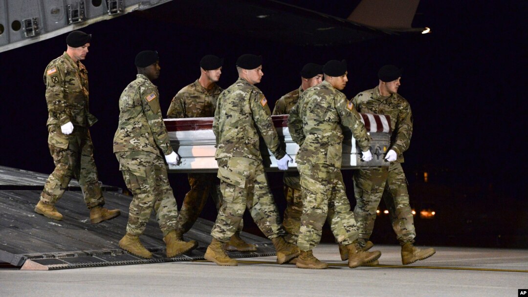 In this image provided by the U.S. Air Force, a U.S. Army carry team transfers the remains of Army Staff Sgt. Dustin Wright of Lyons, Georgia, Oct. 5, 2017, upon arrival at Dover Air Force Base, Delware. Wright, 29, was one of four U.S. troops and four Niger forces killed in an ambush by dozens of Islamic extremists. 