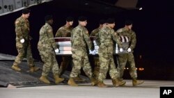 In this image provided by the U.S. Air Force, a U.S. Army carry team transfers the remains of Army Staff Sgt. Dustin Wright of Lyons, Georgia, Oct. 5, 2017, upon arrival at Dover Air Force Base, Delware. Four U.S. troops and four Niger forces killed in an ambush by dozens of Islamic extremists on a joint patrol of American and Niger Force. 