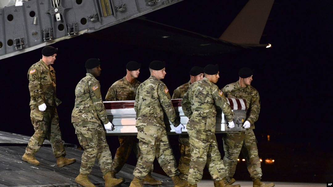 In this image provided by the U.S. Air Force, a U.S. Army carry team transfers the remains of Army Staff Sgt. Dustin Wright of Lyons, Ga., Oct. 5, 2017, upon arrival at Dover Air Force Base, Del. Wright, 29, of Lyons, Ga., was one of four U.S. troops and four Nigerien forces killed in an ambush by dozens of Islamic extremists on a joint American-Nigerien patrol. 