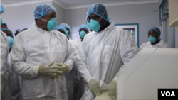 Obediah Moyo, Zimbabwe’s Health Minister (left) speaking to officials at a hospital in Harare, March 02, 2020, which is being used as facility to treat patients who would have been suspected of contracting COVID-19. (Columbus Mavhunga/VOA)