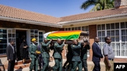 Pallbearers carry the coffin of former Zimbabwe President Robert Mugabe for a mass at the family homestead in Kutama village, 80km northwest of Harare, Sept. 17, 2019. Mugabe is to be entombed this weekend at his home village.