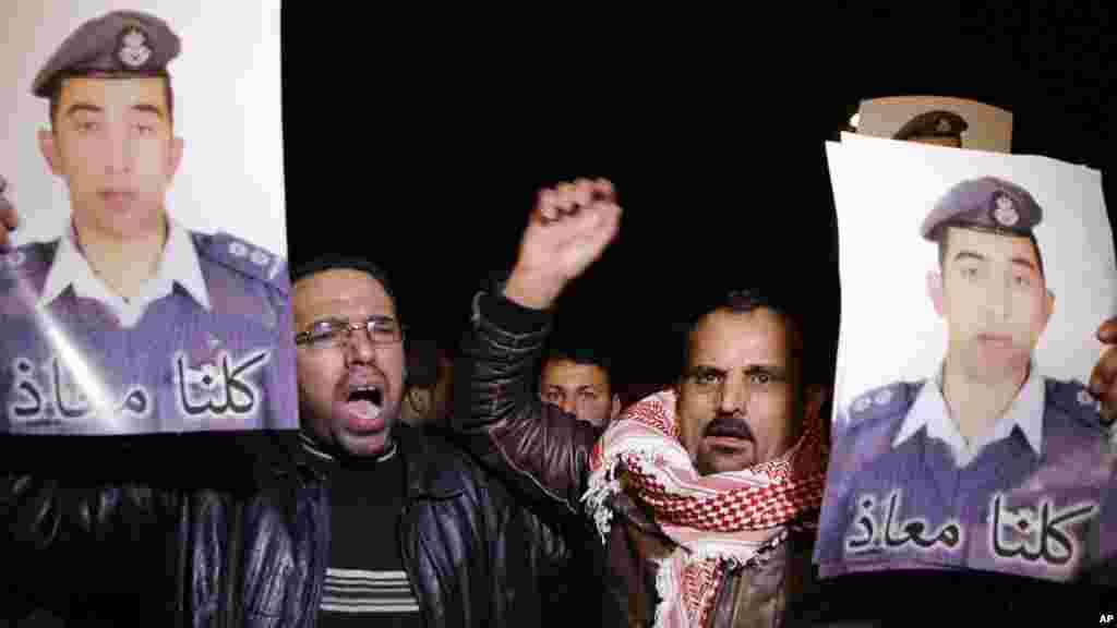 People from the al-Kaseasbeh tribe and other tribes take part in a demonstration outside of Jordan's cabinet in Amman calling for the release of Jordanian pilot Lt. Mu'ath al-Kaseasbeh, who is held by Islamic State group militants, Jan. 27, 2015.