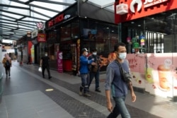 Pedestrian wear face masks on a shopping district in Kuala Lumpur, Malaysia, Jan. 14, 2021.
