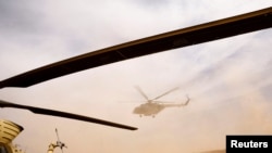 FILE - An Iraqi Army helicopter flies during a military operation against Islamic State militants in the desert of Anbar, Iraq, April 23, 2022. 