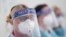 In this April 16, 2020, photo, medical staff receive training on how to use personal protective equipment to avoid coronavirus transmission in Manchester, northern England.