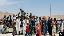 FILE - Hundreds of people gather outside the international airport in Kabul, Afghanistan, Aug. 17, 2021. Some of those unable to leave Afghanistan before the American military withdrawal include winners of the diversity visa program.