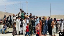 FILE - Hundreds of people gather outside the international airport in Kabul, Afghanistan, Aug. 17, 2021. Some of those unable to leave Afghanistan before the American military withdrawal included winners of the diversity visa program.