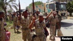 FILE - Members of Iraqi security forces arrive in Anbar Province to reinforce security forces in Ramadi, June 17, 2014. 