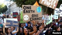 Activists march in a climate change rally in London, Britain, Sept. 20, 2019.