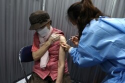 FILE - A South Korean elderly woman receives her first dose of the Pfizer-BioNTech coronavirus vaccine at a vaccination center in Seoul, South Korea, April 1, 2021.