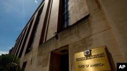 FILE - Signage is seen at the entrance to the Voice of America headquarters building in Washington, June 15, 2020.