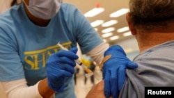 Nursing student Erika Lohr vaccinates a patient as California opens up vaccine eligibility to any residents 16 years and older during the outbreak of coronavirus disease, in Chula Vista, California, April 15, 2021. 